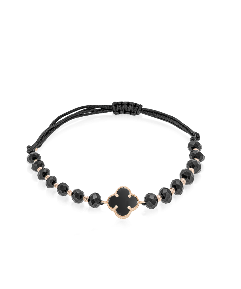 Mustast lõngast käevõru kulla ja oonüksitega