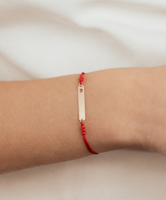 Punasest lõngast käevõru kullast ripatsiga "Süda"