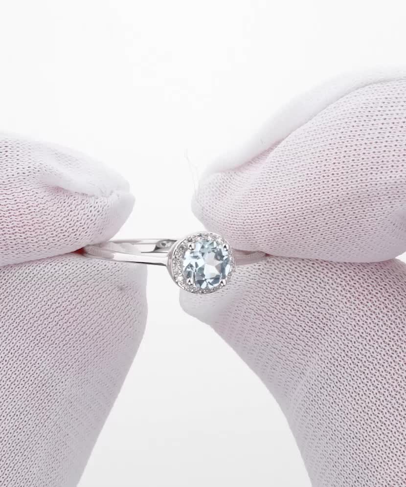 Valgest kullast sõrmus topaasi ja teemantidega