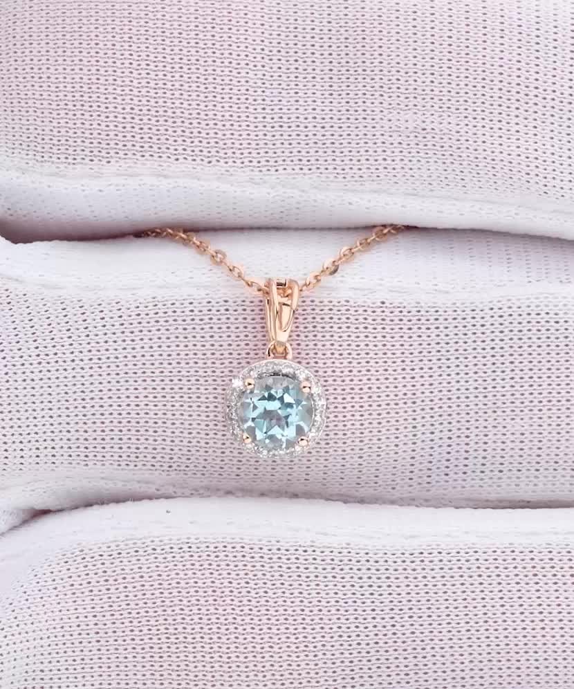 Kuldne ripats topaasi ja teemantidega